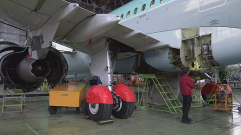 Engineer technician inspects the inside of the aircraft with a flashlight.4k Stock Footage 98001037
