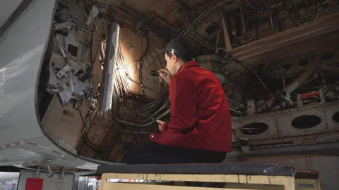 Engineer technician inspects the inside of the aircraft with a flashlight. Stock Footage 98001227