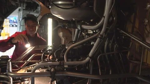 Engineer technician inspects the inside of the aircraft with a flashlight. Stock Footage 98002385