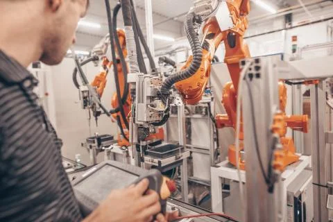 Engineer, technician working with automatic robot in automotive industrial Фото