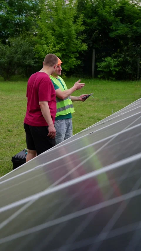 An engineer tells the customer about the relevance and operation of solar panels Stock Footage 314797555