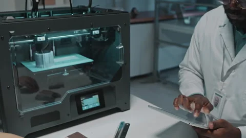 Engineer Testing 3D Printing Machine with Digital Tablet Stock Footage 257708648
