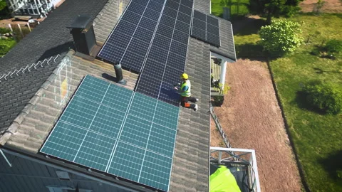 Engineer testing and adjusting solar panels on a house roof - CGI render Stock Footage 257588801
