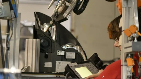 Engineer testing automatic industrial robot, glueing headlamp station 動画素材 124603680