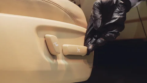 Engineer Testing Electric Seat Adjustment Buttons with Black Gloves for Stock Footage 257580830