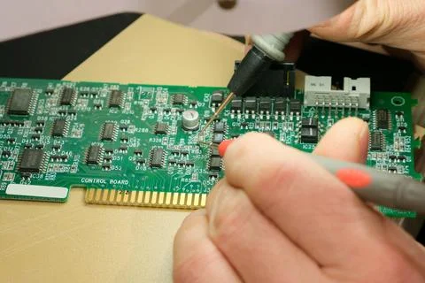 The Engineer testing the printed circuit board of an electronic device Stock Photos