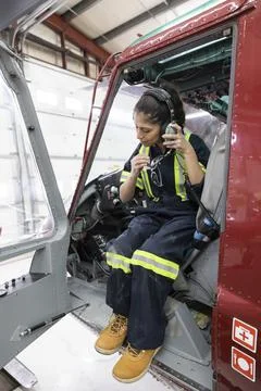 Engineer testing radio headset in helicopter Foto stock