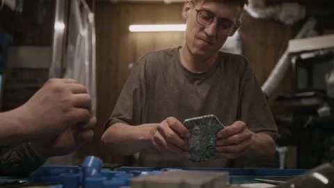 Engineer Testing Recycled Plastic Tile for Durability while Developing Sample Stock Footage 287990788