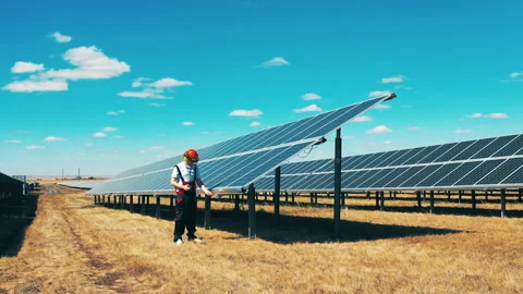 Engineer testing solar panel voltage and current with multimeter. Renewable, eco Stock Footage 142203404