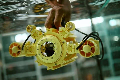 Engineer Testing Underwater Drone Prototype in Water Tank Stock Photos