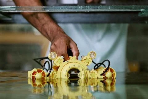 Engineer Testing Yellow Underwater Drone in Water Tank Stock Photos