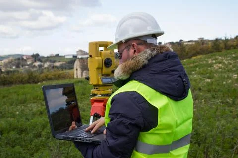 Engineer with a theodolite for measuring topographic Stock Photos
