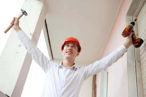 Engineer with a tools in raised hands Stock Photos