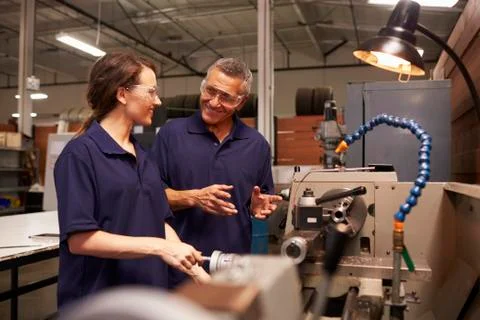 Engineer Training Female Apprentice On Milling Machine Stock Photos