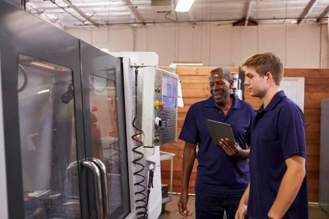 Engineer Training Male Apprentice On CNC Machine 스톡 사진