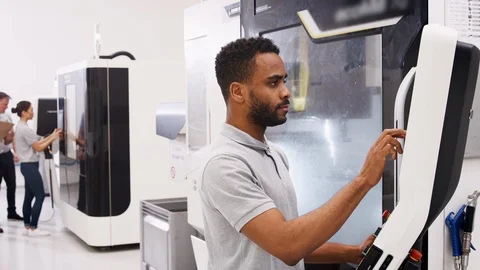 Engineer Training Male Apprentice To Use CNC Machine In Factory Video stock 95509149