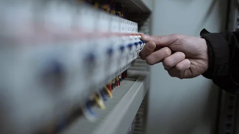 The engineer turns off the circuit breakers in the electrical panel Stock Footage 92865355