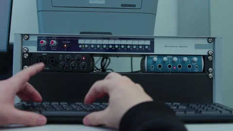 An engineer is typing on a computer keyboard and switching buttons Video stock 334108425