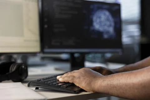 Engineer typing on keyboard, doing data center automation using AI Stock Photos