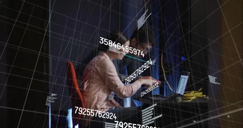Engineer typing on laptop in data center initiating overlays adjusting cables as Stock Footage 313704422
