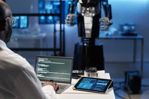 Engineer typing security codes on laptop Stock Photos
