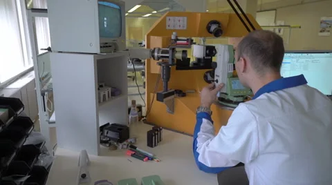 Engineer in uniform checking quality of theodolite Stock Footage 65014057
