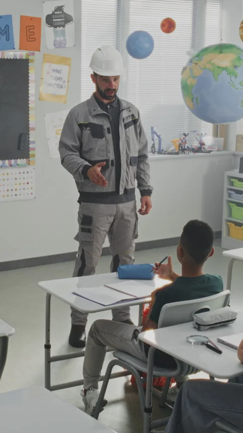 Engineer in Uniform Giving Lecture to Curious Primary School Students About Stock Footage 316067850