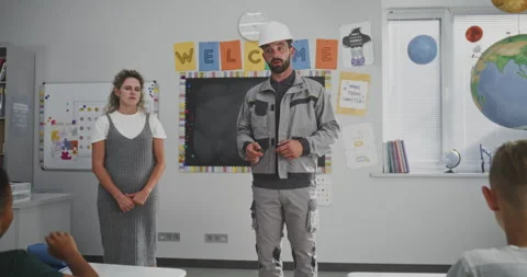 Engineer in Uniform Speaking and Giving Lecture to Curious Primary School Stock Footage 316050477