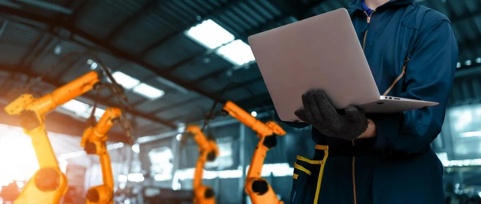Engineer use advanced robotic software to control industry robot arm in factory 스톡 사진
