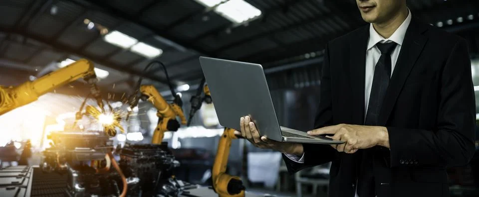 Engineer use advanced robotic software to control industry robot arm in factory 스톡 사진
