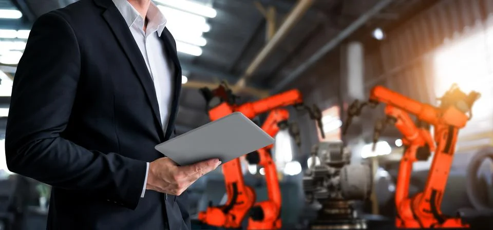 Engineer use advanced robotic software to control industry robot arm in factory 스톡 사진