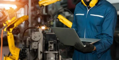 Engineer use advanced robotic software to control industry robot arm in factory 스톡 사진