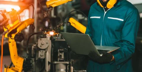Engineer use advanced robotic software to control industry robot arm in factory 스톡 사진