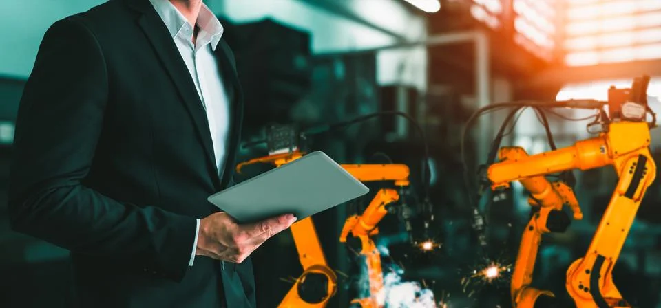 Engineer use advanced robotic software to control industry robot arm in factory 스톡 사진