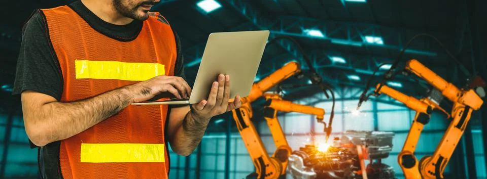 Engineer use advanced robotic software to control industry robot arm in factory 스톡 사진