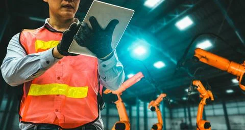 Engineer use advanced robotic software to control industry robot arm in factory 스톡 사진