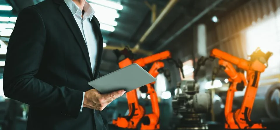 Engineer use advanced robotic software to control industry robot arm in factory 스톡 사진