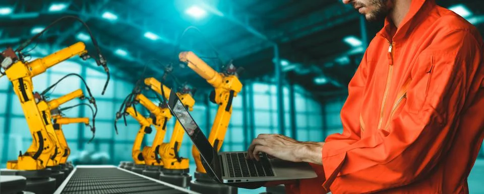 Engineer use advanced robotic software to control industry robot arm in factory 스톡 사진