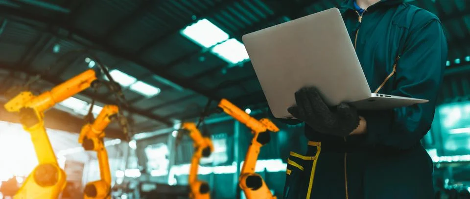 Engineer use advanced robotic software to control industry robot arm in factory 스톡 사진