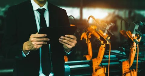 Engineer use advanced robotic software to control industry robot arm in factory 스톡 사진