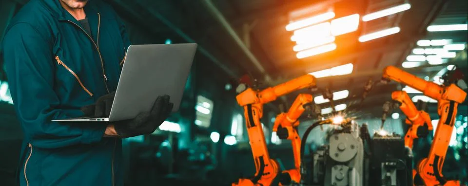 Engineer use advanced robotic software to control industry robot arm in factory 스톡 사진