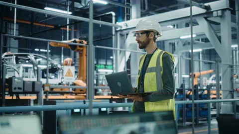 Engineer Use laptop in Car Factory Stock Footage 159014579