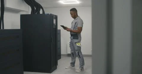 Engineer uses digital tablet to analyze and set up energy system 写真素材