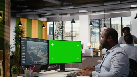 Engineer uses green screen mockup PC to do clean energy production testing Stock Footage 315616714