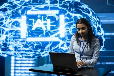 Engineer uses laptop and headset next to neural network visualization Stock Photos