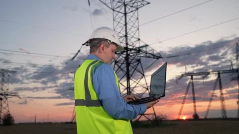 Engineer uses laptop for power transmission lines condition diagnostic Stock Footage 259521838