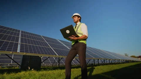 Engineer Uses Laptop for Solar Panel Performance Analysis Stock Footage 296848676
