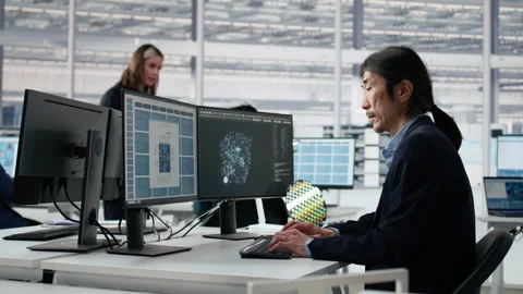 Engineer uses VR glasses to examine microchip circuit layout in RD office Stock Footage 335881855