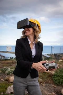 An engineer uses VR headsets and a remote control at a factory during an in.. Stock Photos