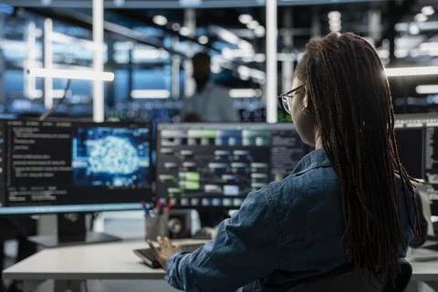 Engineer using AI computer to do checkup in server room Stock-Fotos